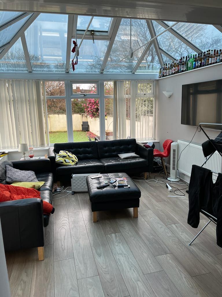 Spacious living room with abundant natural ligh...
