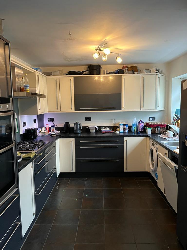 Spacious kitchen featuring modern cabinetry and...