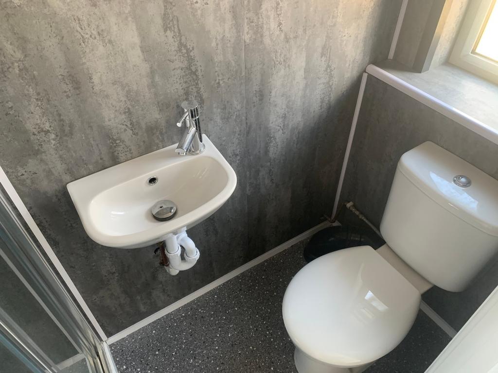 A well-maintained single toilet featuring moder...