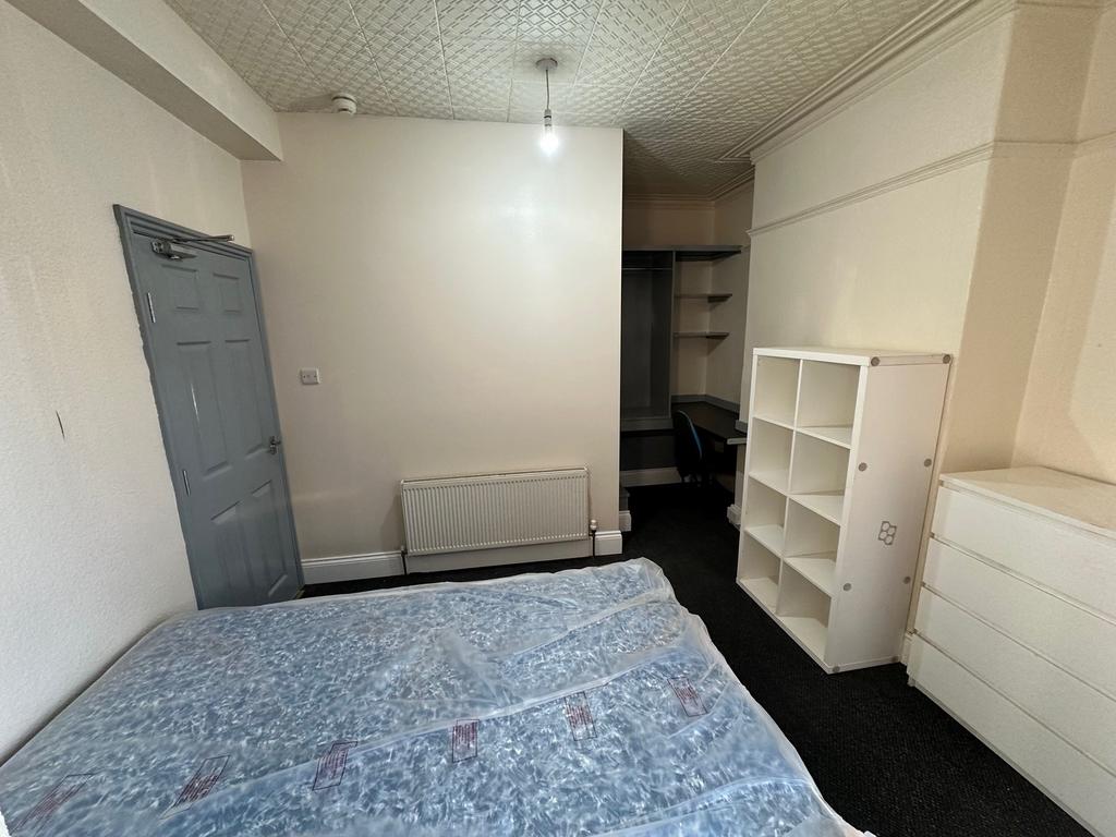 Spacious double bedroom featuring ample natural...
