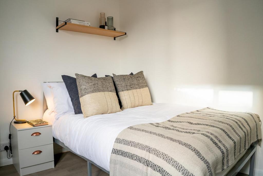 A bright and inviting double bedroom featuring ...