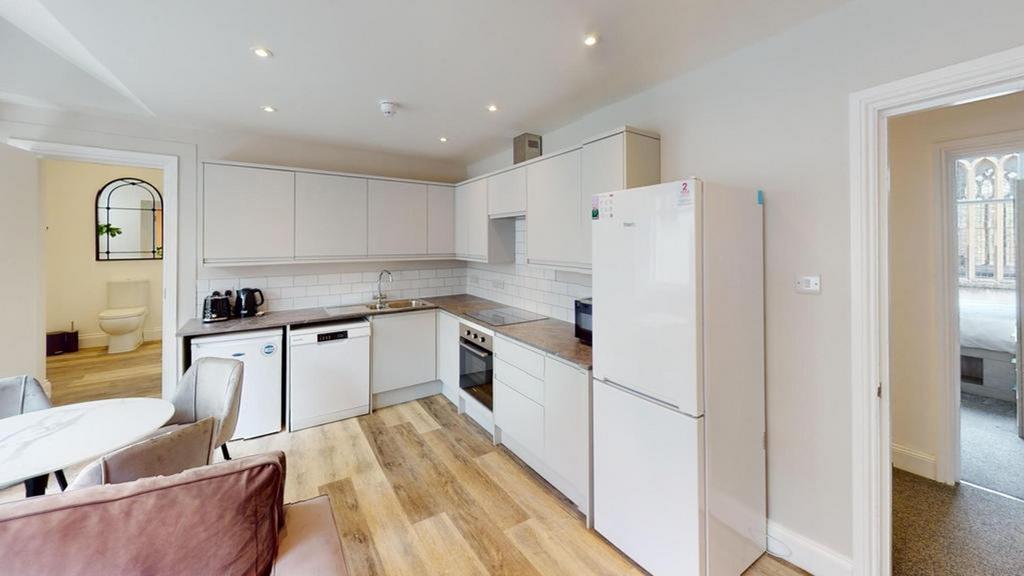 A bright and modern kitchenette with ample spac...