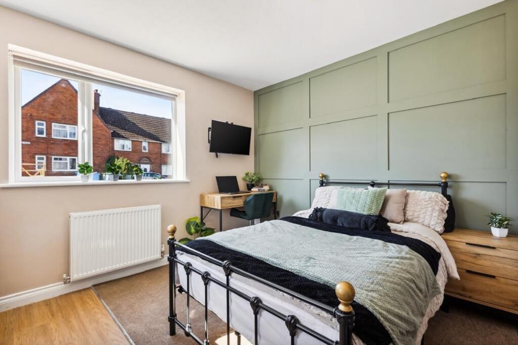 This inviting double bedroom features a cozy am...