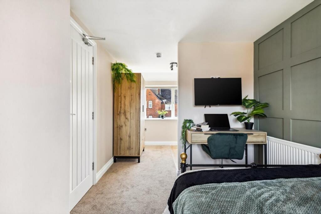 This inviting double bedroom features a stylish...
