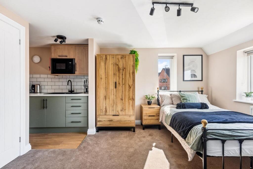Spacious and stylish double bedroom featuring a...