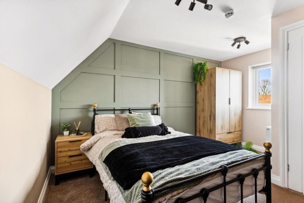 This charming double bedroom features a cozy am...