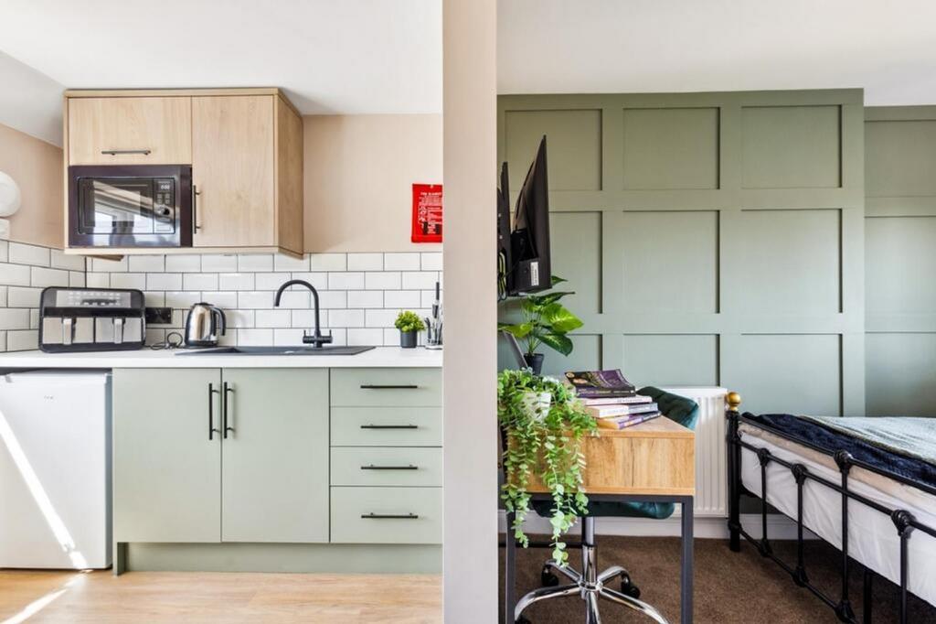 This modern kitchen features stylish cabinetry ...