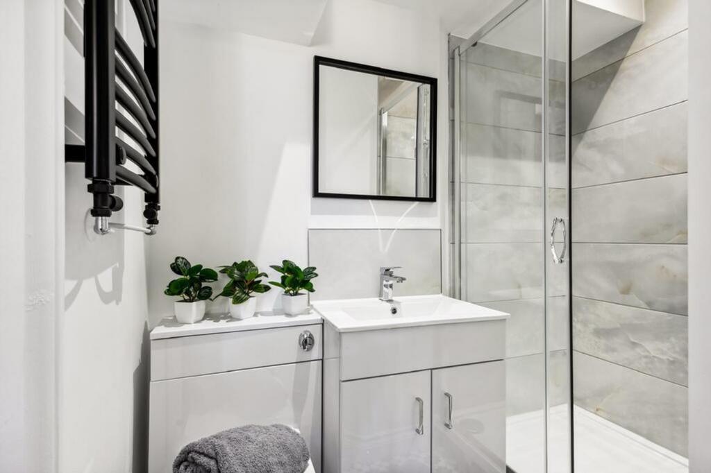 This stylish bathroom features a modern shower ...