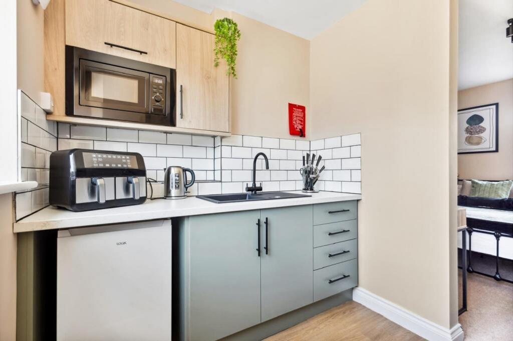 Charming and modern kitchenette featuring sleek...
