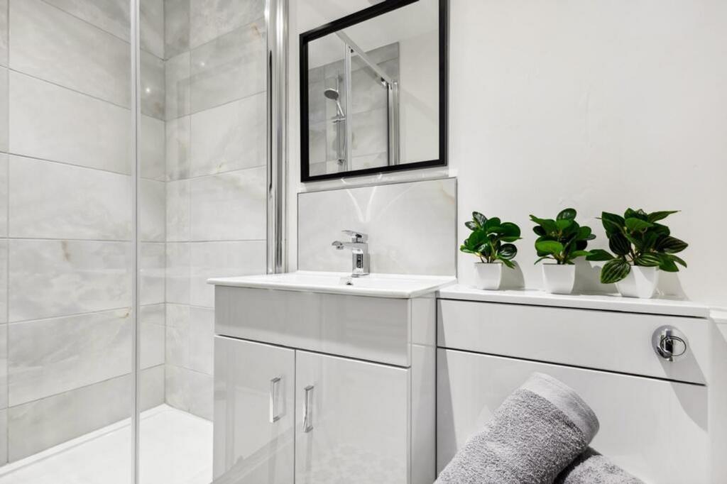 This modern bathroom features a sleek design wi...