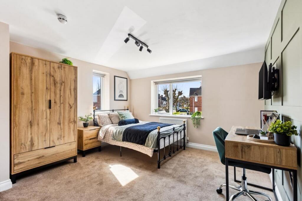 This inviting double bedroom features a cozy be...
