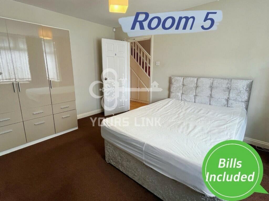 A spacious and well-lit double bedroom, perfect...