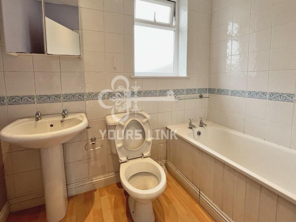 A spacious and clean bathroom featuring a bath,...