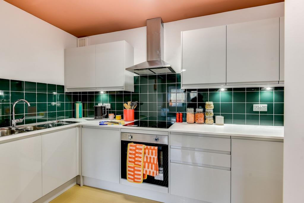 This modern kitchen features sleek cabinetry, a...