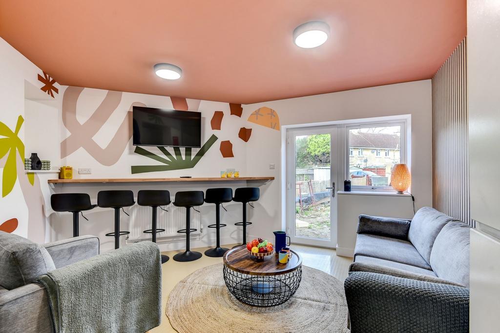 This vibrant communal lounge features modern de...