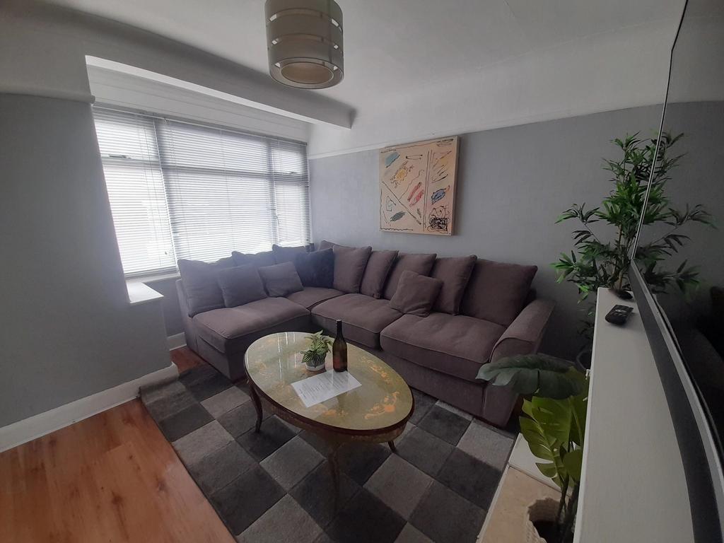 A spacious and inviting living room featuring a...