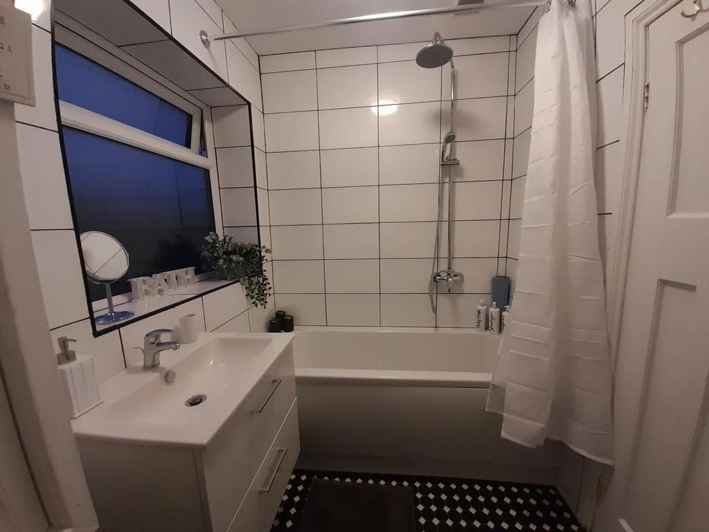 Modern bathroom featuring a stylish bathtub and...