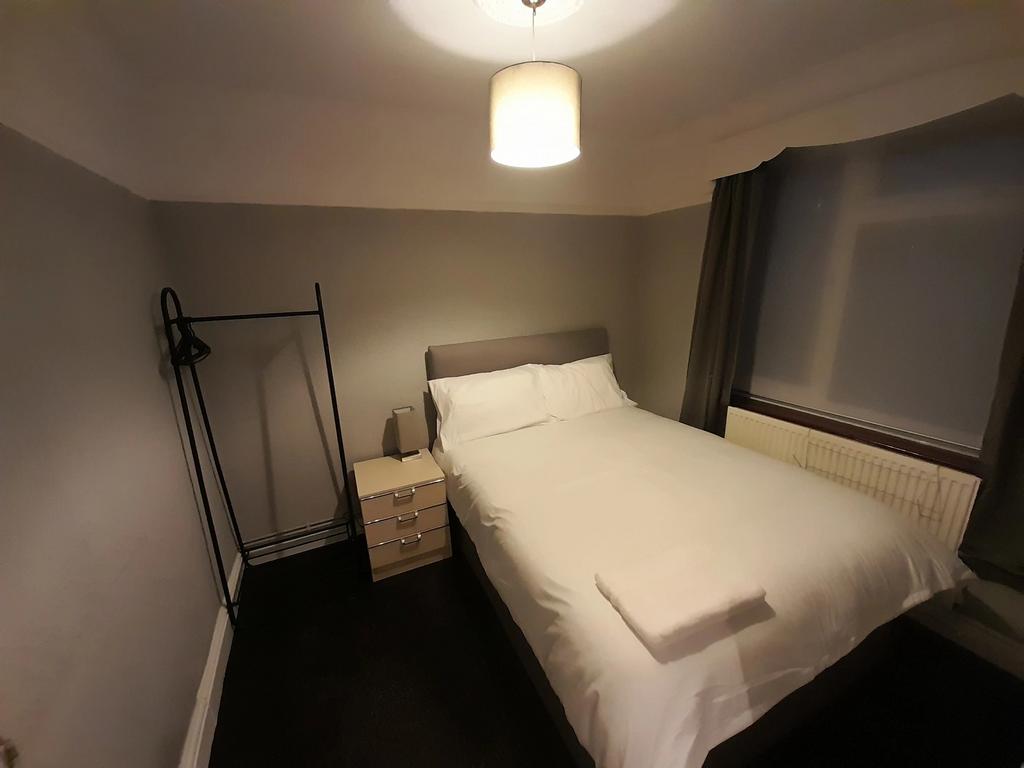 This spacious double bedroom features a comfort...