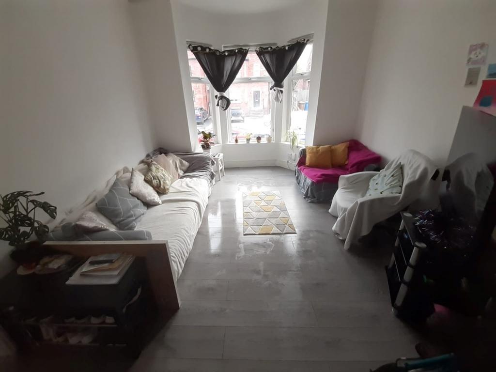 A cozy living room featuring large windows that...