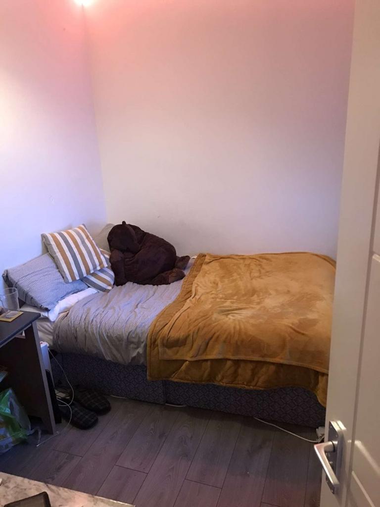 Cozy double bedroom featuring a comfortable bed...