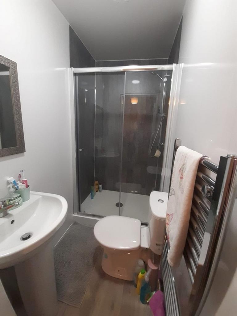 A modern bathroom featuring a sleek shower encl...