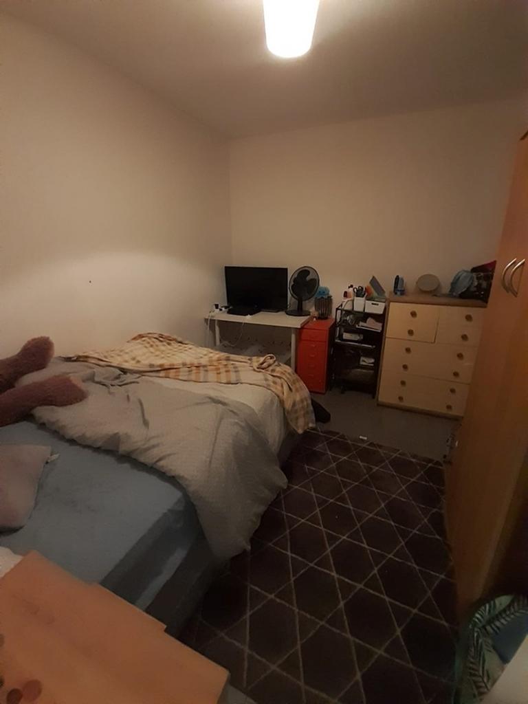 Cozy double bedroom featuring a comfortable bed...