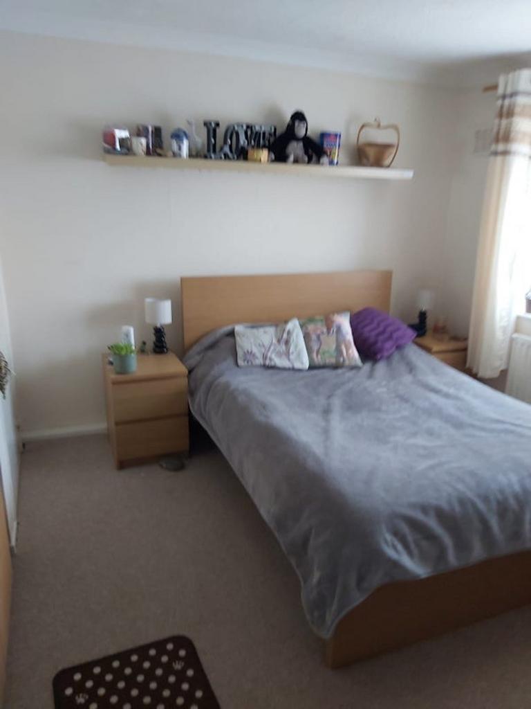 This charming double bedroom features a cozy at...