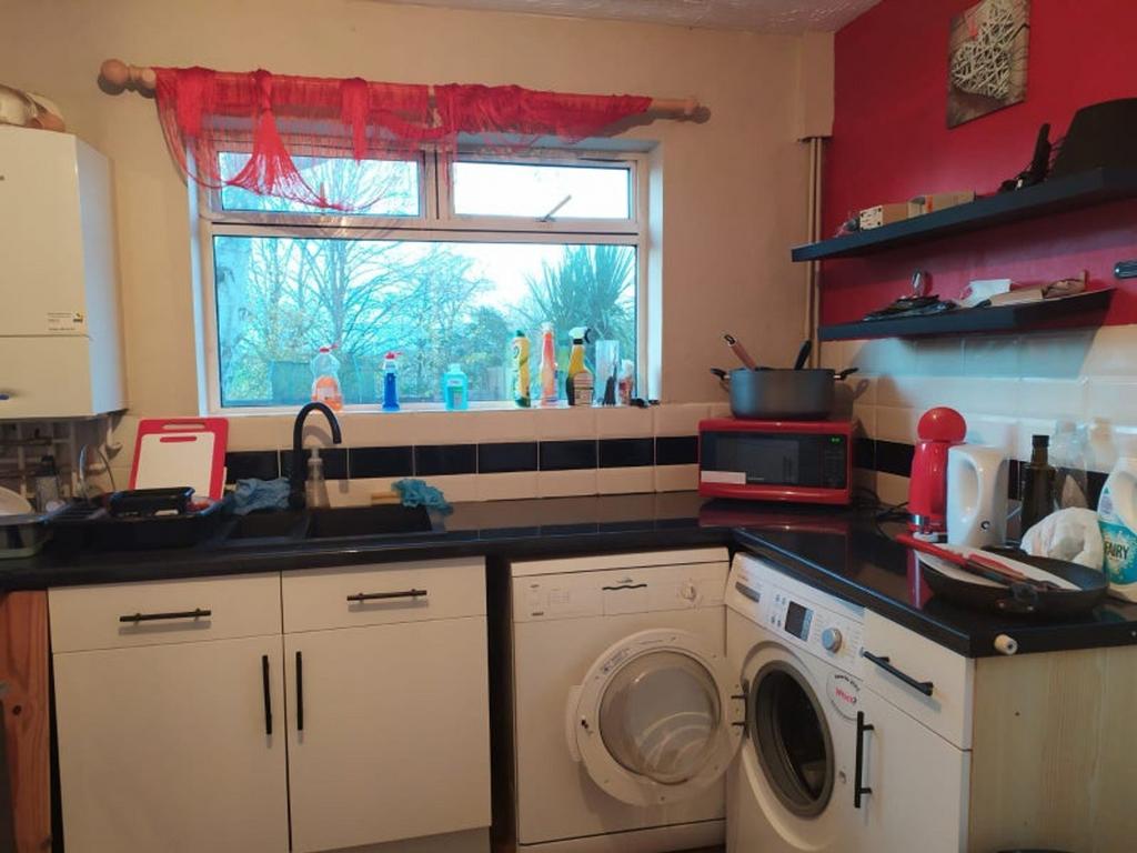 A cozy kitchen featuring essential appliances, ...