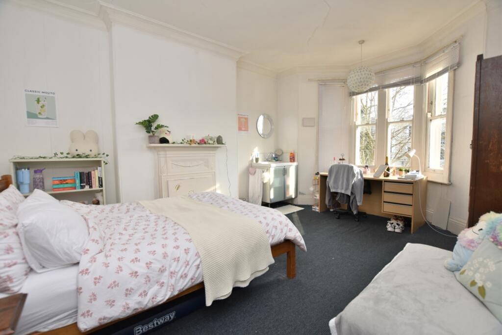 Spacious double bedroom featuring large windows...