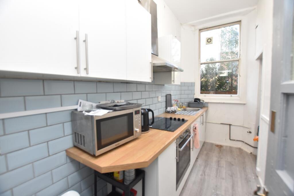 A bright and modern kitchen featuring sleek cab...