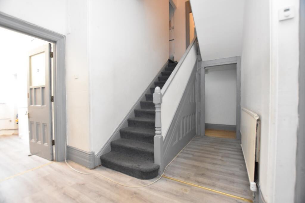 A well-maintained hallway featuring stylish gre...