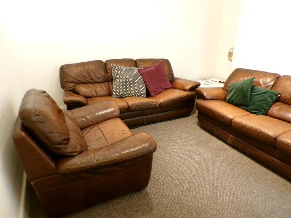 A cozy living room featuring comfortable leathe...