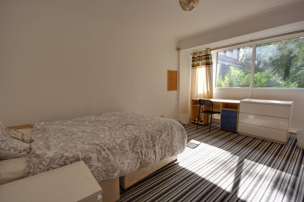 A spacious and bright double bedroom featuring ...