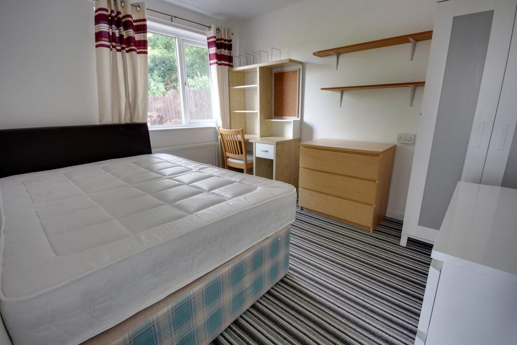 A bright and inviting double bedroom featuring ...