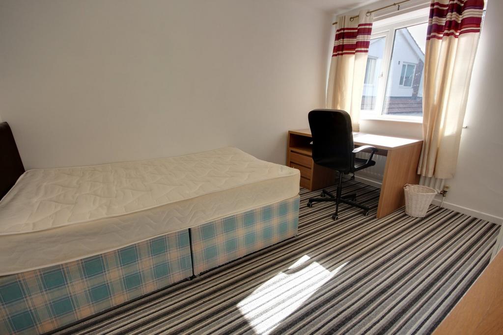 A spacious and well-lit double bedroom, perfect...