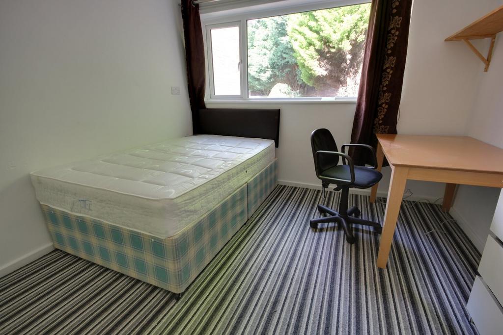 A bright and tidy double bedroom featuring a co...
