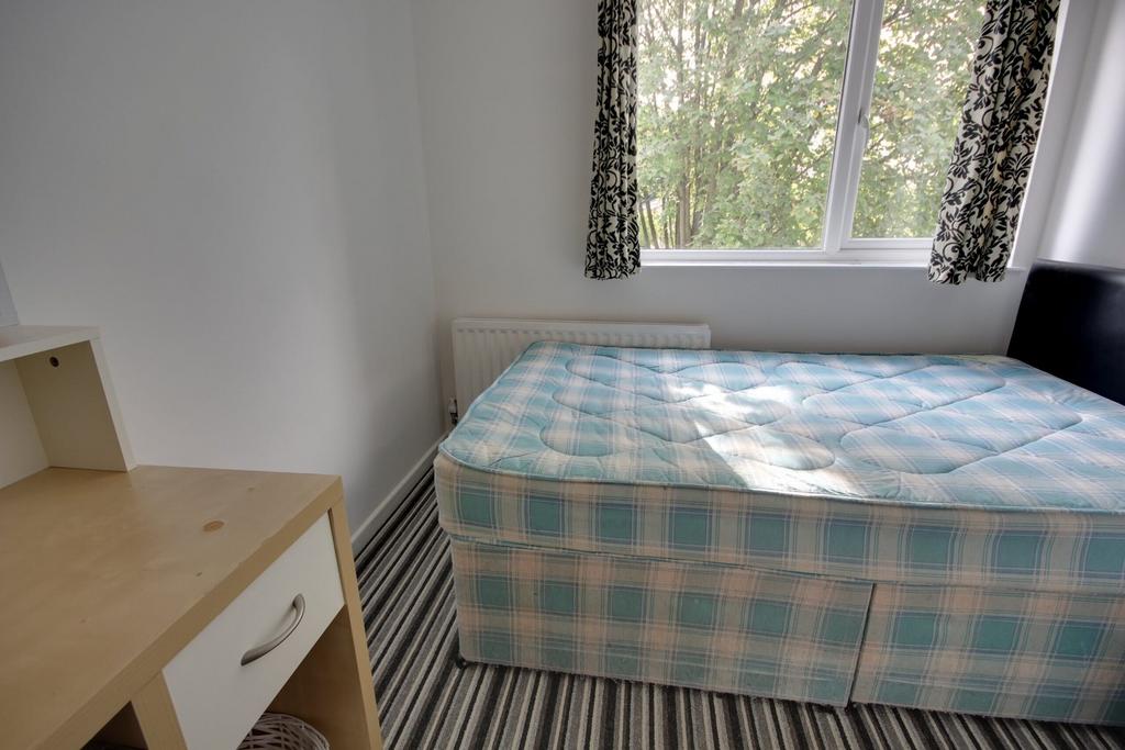 A cozy double bedroom with natural light, featu...