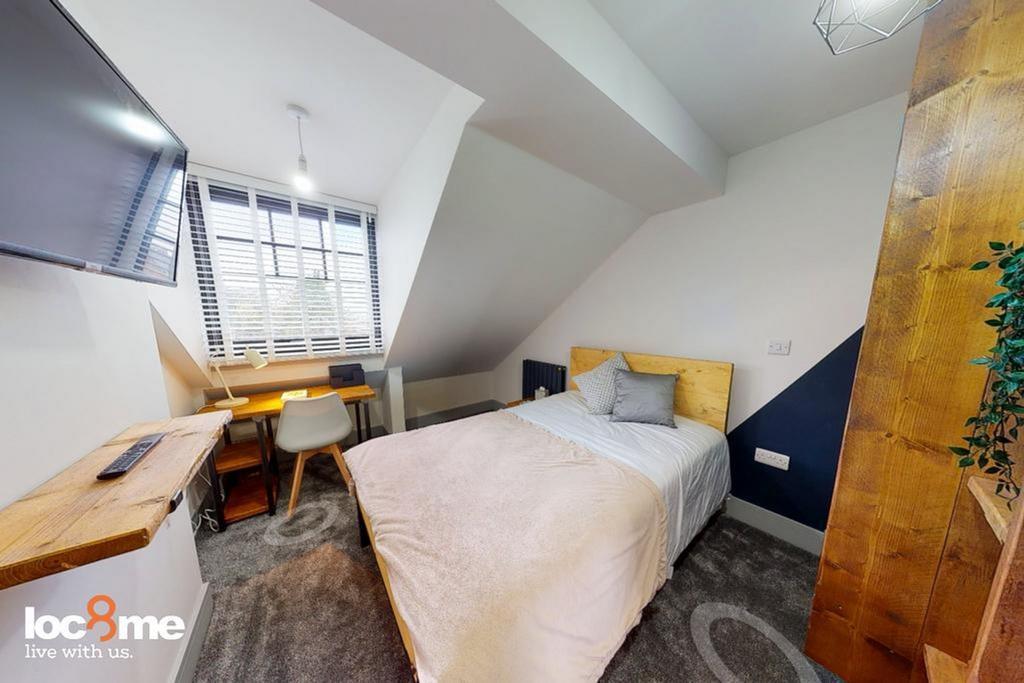 A stylish and well-lit double bedroom perfect f...
