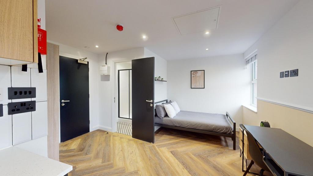 A bright and inviting double bedroom with moder...