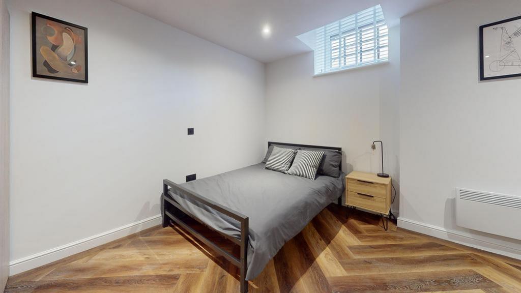A modern and stylish double bedroom featuring p...