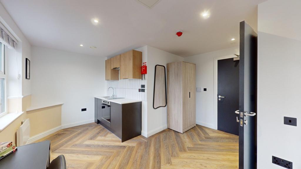 A modern kitchenette with stylish finishes, per...