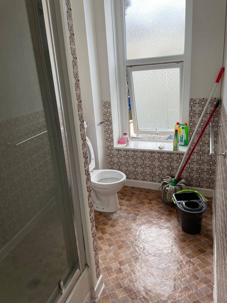 Bright and functional bathroom featuring a spac...