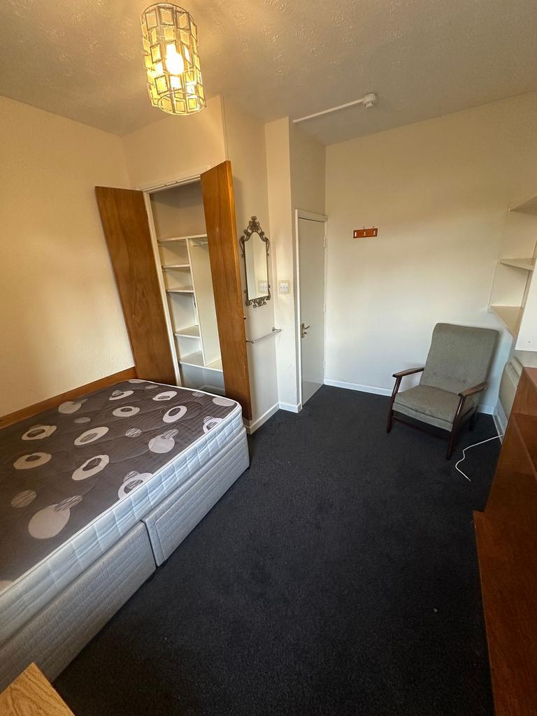 Neat furnished bedroom with a comfortable bed, ...