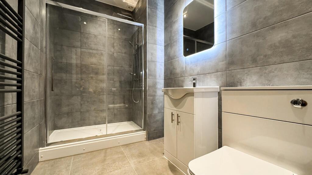 A modern bathroom featuring sleek fixtures and ...