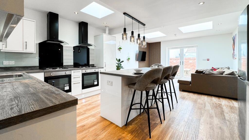 This modern kitchen features sleek cabinetry an...