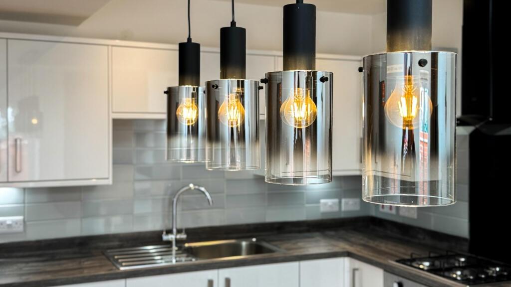 Modern kitchen featuring sleek cabinetry, styli...