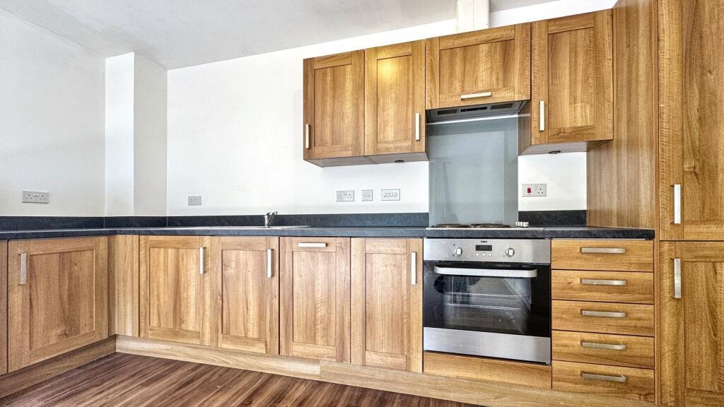 Modern kitchen featuring sleek wooden cabinetry...