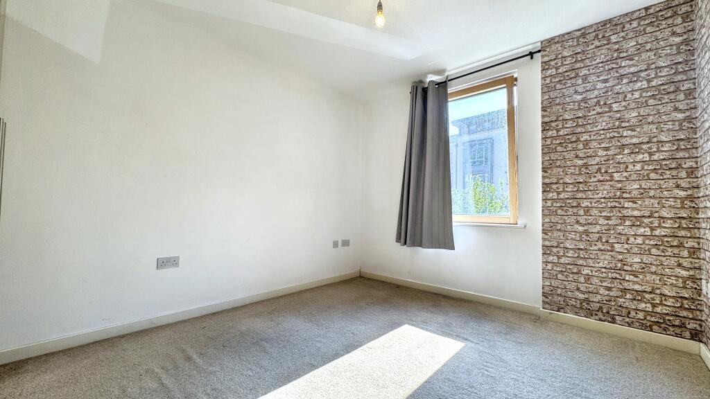 This charming double bedroom features ample nat...