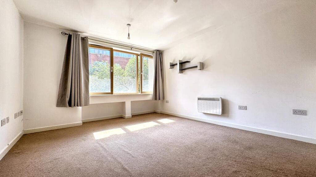 A bright and inviting living room featuring lar...