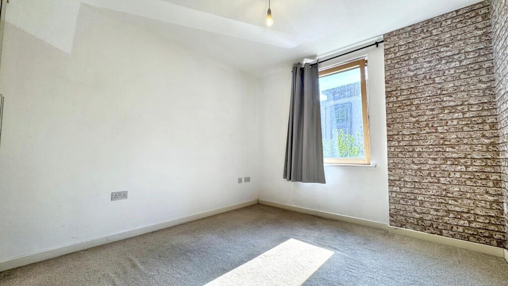 A bright and inviting double bedroom featuring ...